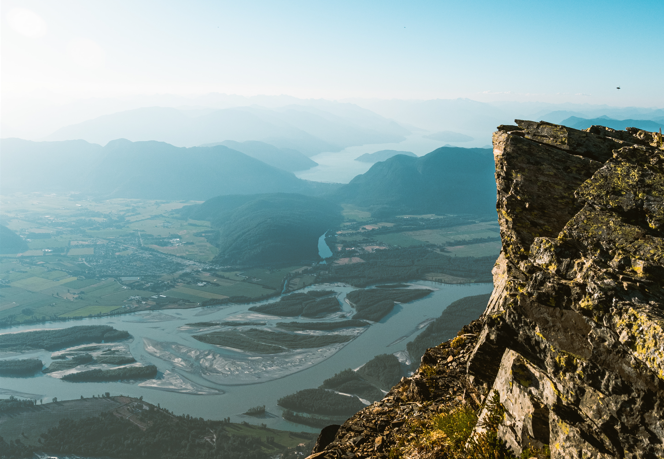 The edge of a rocky cliff overlooking a scenic view of the Fraser Valley